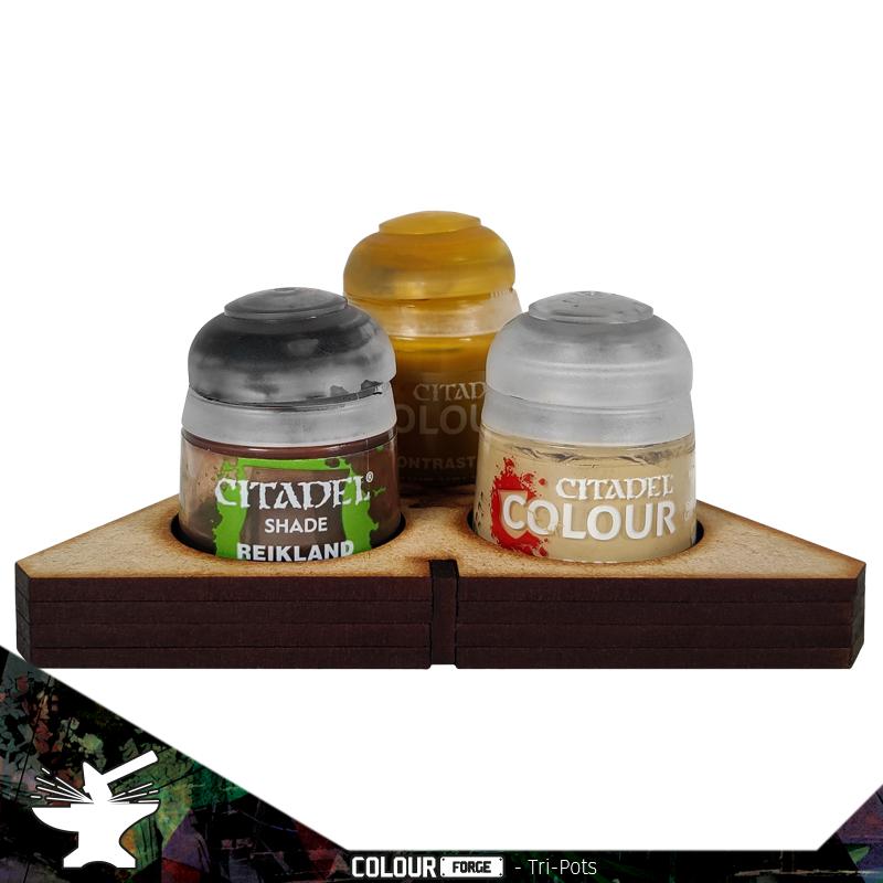 Tri-Pots holds 3 pots of any Citadel paint or wash so that you can avoid those nasty spills! Made from precision laser cut 3mm MDF, Tri-Pots ensures you can while away the hours enjoying your hobby without having to worry about knocking several of your precious paints or washes over and runing your workspace.Dimensions 98mm L x 98mm W x 14mm HInstructions are available online at www.thecolourforge.com Tri-Pots comes unpainted and unassembled. We recommend using Colour Forge basing glue for best results. The Colour Forge Tri-Pots - TCF-ACC-014 - 5060843102410